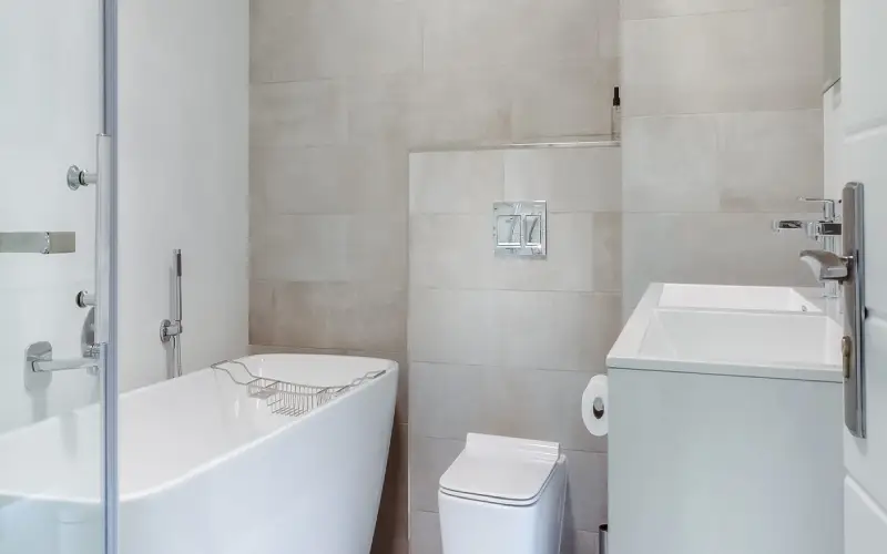 Modern white bathroom with tub and sink highlighting a bathroom remodel in Seattle.