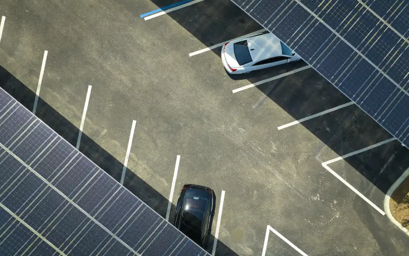 Solar panels installed over parking lot for parked cars for effective generation of clean energy