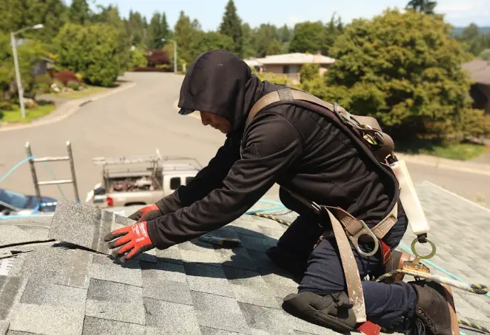 Experienced roofing contractor in South King County working on shingle placement for a safe, sturdy roof.