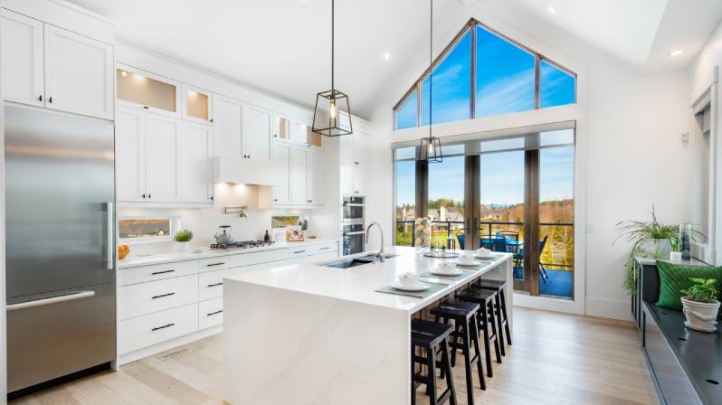 Bright kitchen with vaulted ceiling and light and neutral cabinet color.
