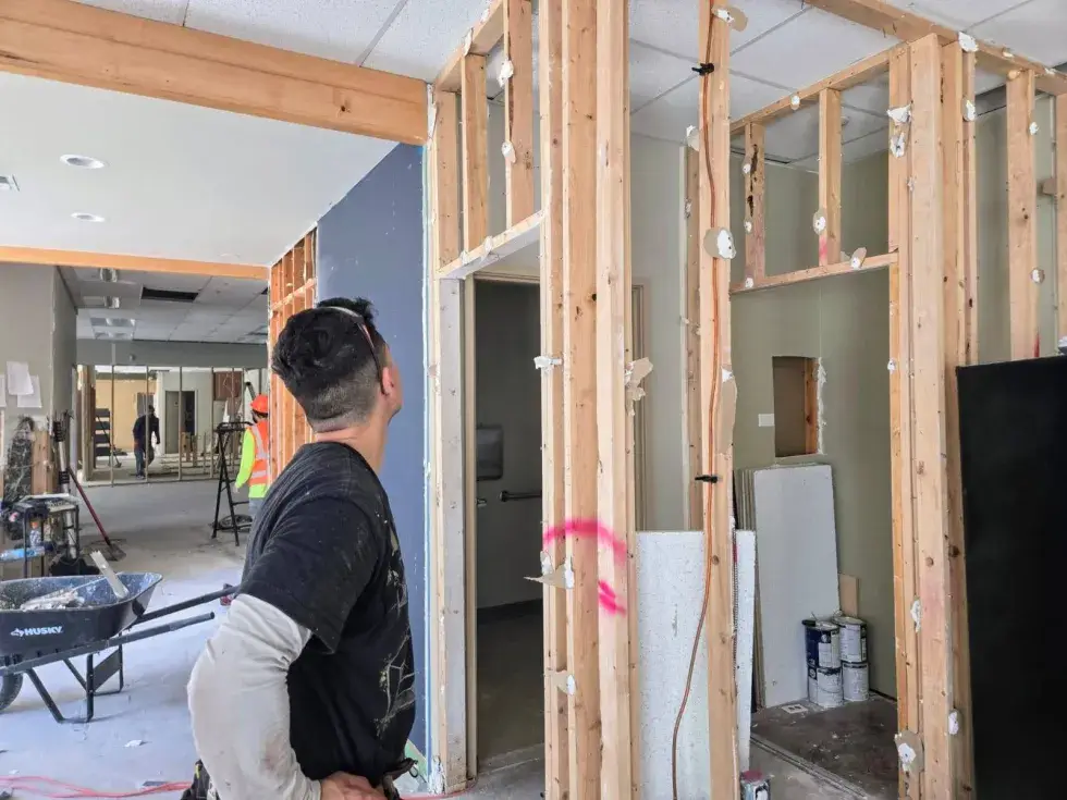 Contractor inspecting interior framing for home remodeling services in South King County during renovation project.